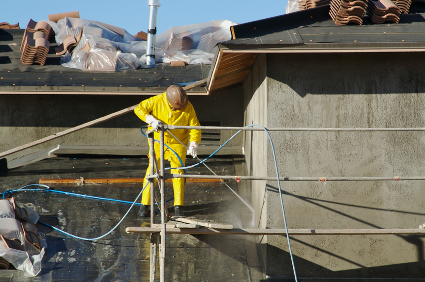 Pressure washing being performed by an employee of professional painting services in Wichita. 