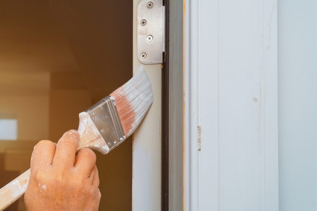 A man demonstrating his cutting skills in exterior painting Newton, KS