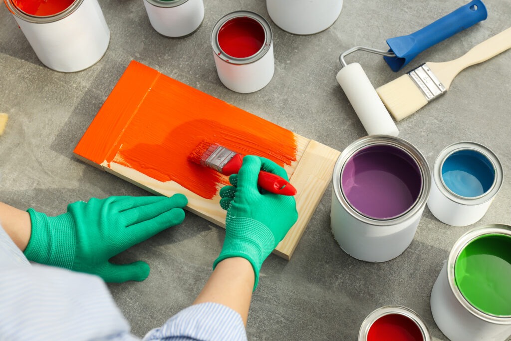 A person considering their paint options before they hire local painting contractors for their home. 