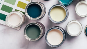 An image of paint in paint cans, which are likely to be used by an exterior painter.