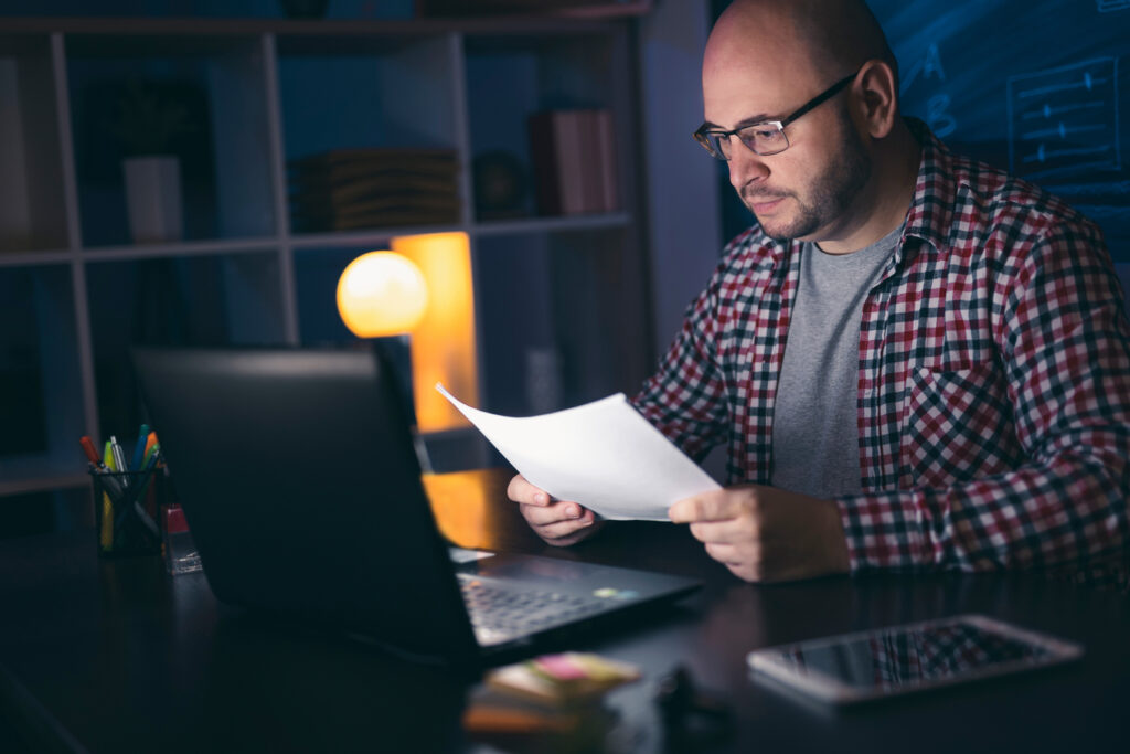 A man researching the top-rated painting company to hire for their home. 