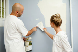 Couple deciding on paint colors after understanding how to paint a house exterior.