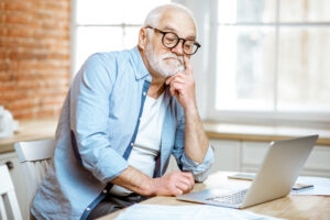 A senior individual researching how to repair vinyl siding.