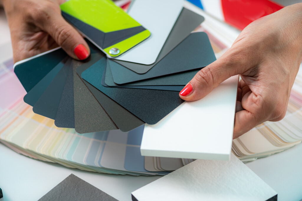 An individual considering different siding colors for their home.
