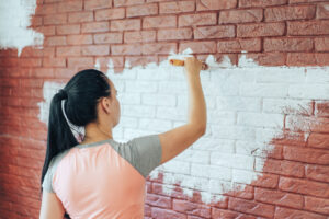 A woman engaged in brick painting.