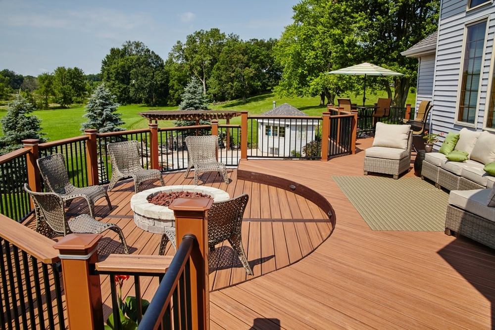 Beautifully painted backyard deck under clear skies, ideal weather conditions showing the best time to paint a deck.