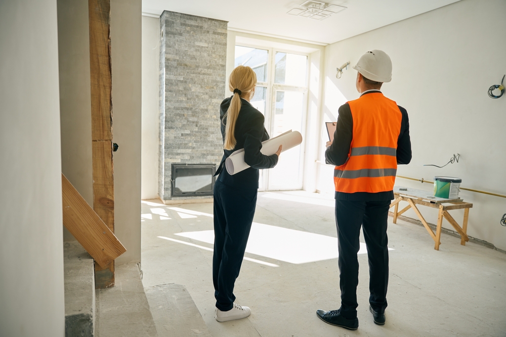 Client and contractor evaluating a partially renovated home — illustrating how to estimate home value after renovation based on layout, upgrades, and materials.