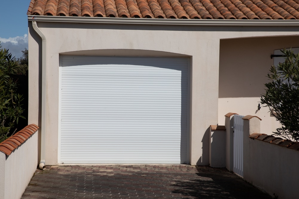 Modern home with a white garage door highlighting that in property renovations garage doors often deliver the highest return on investment